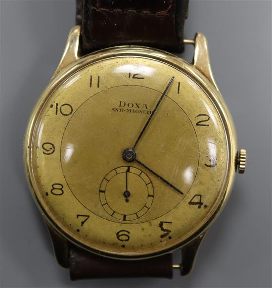 A gentlemans yellow metal Doxa manual wind wrist watch, with subsidiary seconds, on leather strap